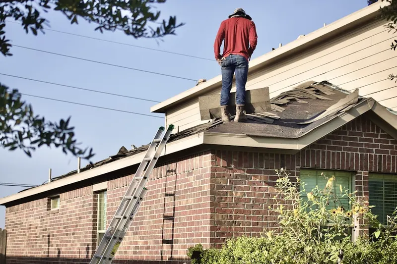Professional roofer working on a residential roof in Jumbo